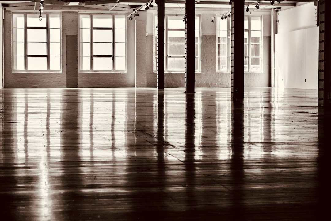 Industrial space with large windows, reflective floor, and pillars in Allen, TX