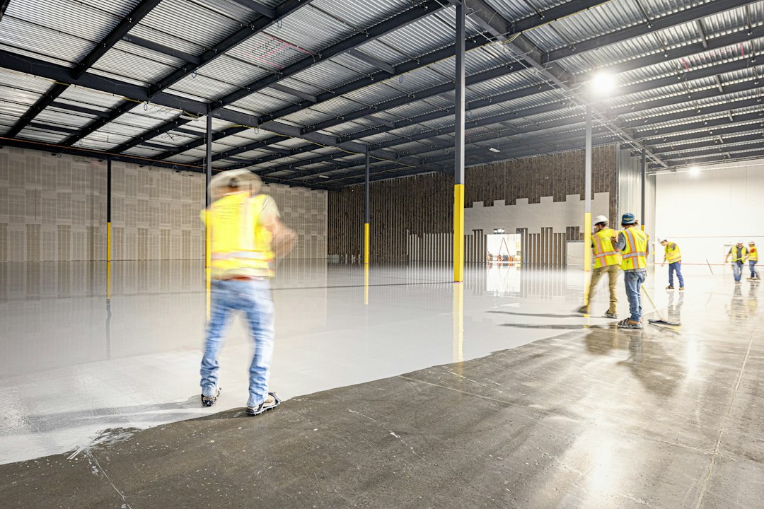 Workers in a large, empty warehouse with polished floors in Allen, TX