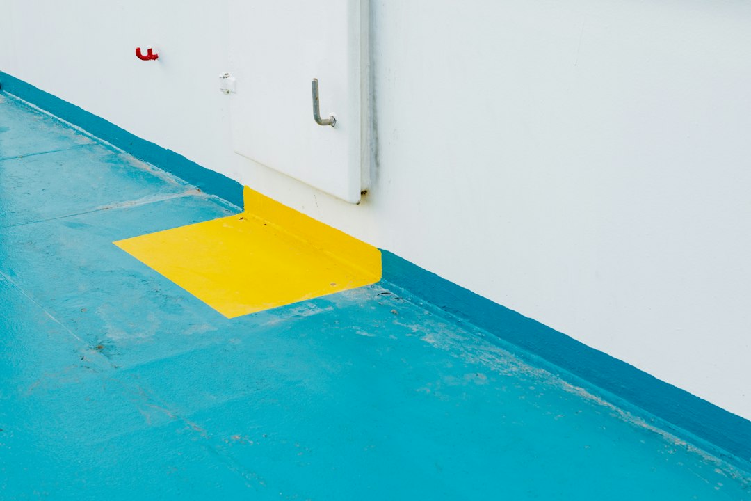 A blue and yellow floor next to a white wall in Allen, TX