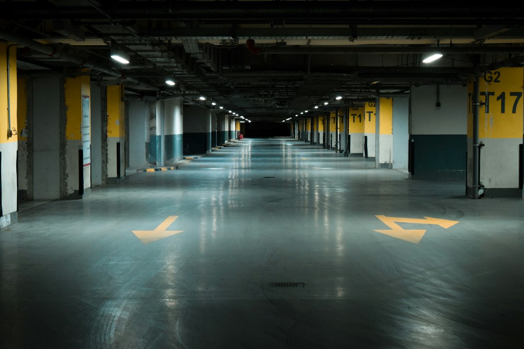 An empty parking garage with yellow arrows painted on the floor in Allen, TX